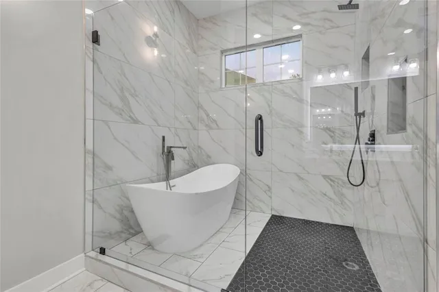 a bathroom with a white bath tub and shower