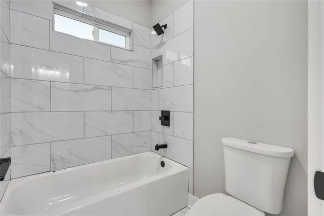 a bathroom with a toilet and bathtub