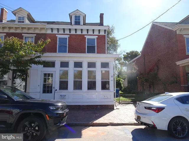 a front view of a house with parking space