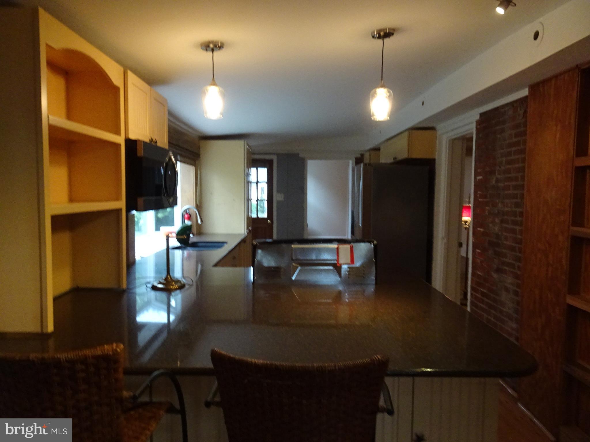 45 West 5th Street, Unit A New Castle, DE 19720 - Photo 11 of 21 a kitchen with sink refrigerator dining table and chairs