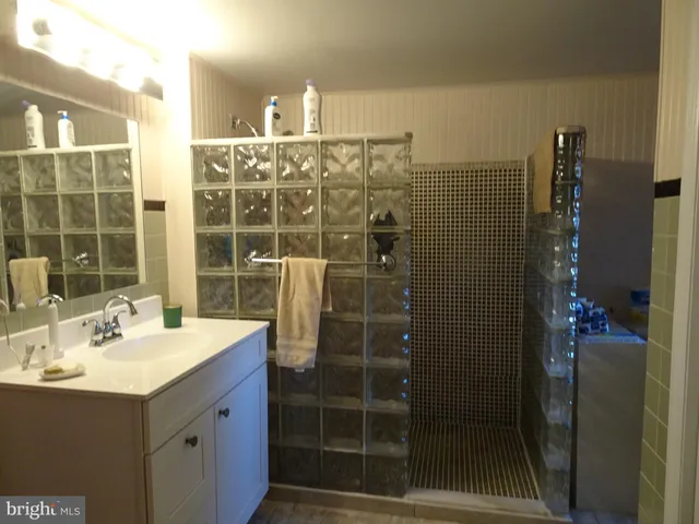 a bathroom with a double vanity sink and a mirror