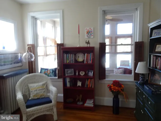 a bedroom with furniture and wooden floor