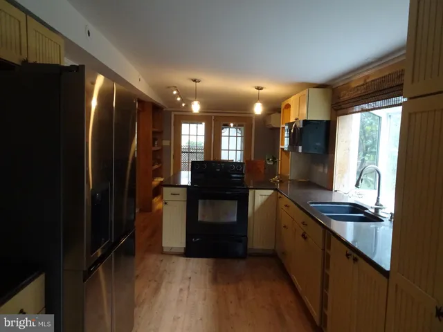 a kitchen with stainless steel appliances granite countertop a refrigerator and a sink