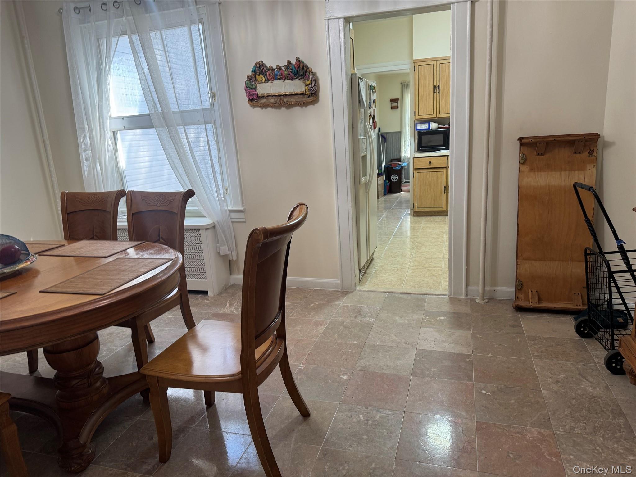 80-58 88th Road Queens, NY 11421 - Photo 7 of 21 a view of a dining room with furniture and a window