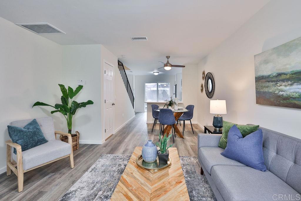 a living room with furniture potted plant and a chandelier