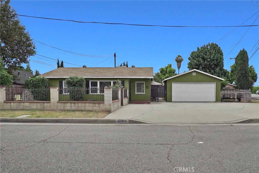 10902 Ranchito Street El Monte, CA 91731 - Photo 1 of 1 a front view of a house with a yard and potted plants