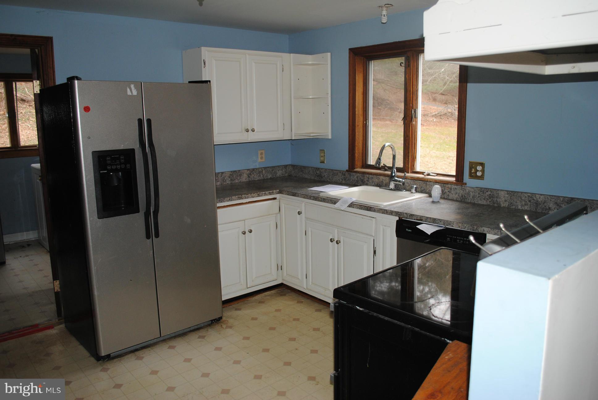2614 Garrett Road White Hall, MD 21161 - Photo 5 of 27 a kitchen with stainless steel appliances granite countertop a sink stove and refrigerator