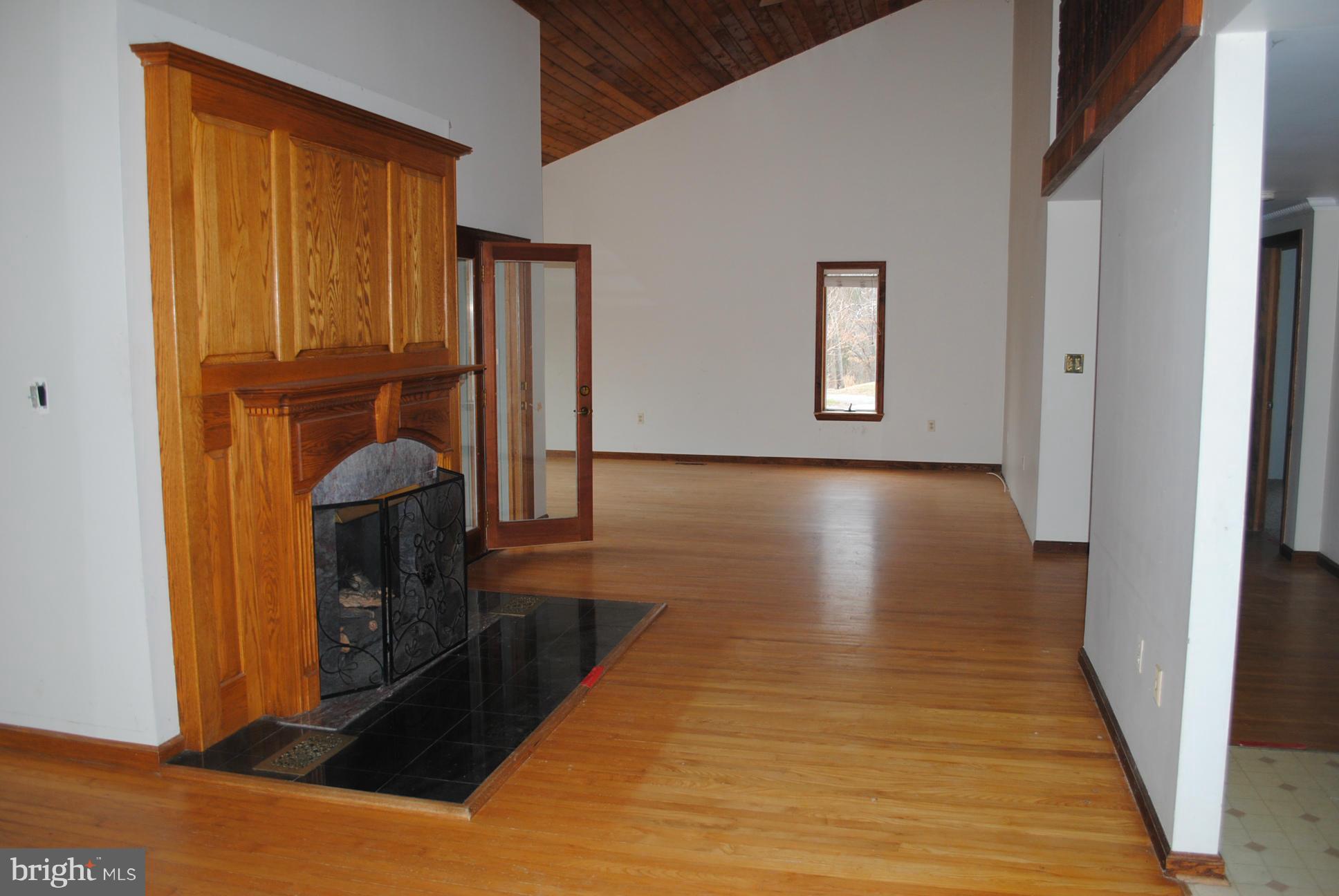 2614 Garrett Road White Hall, MD 21161 - Photo 9 of 27 a view of a hallway with wooden floor and staircase