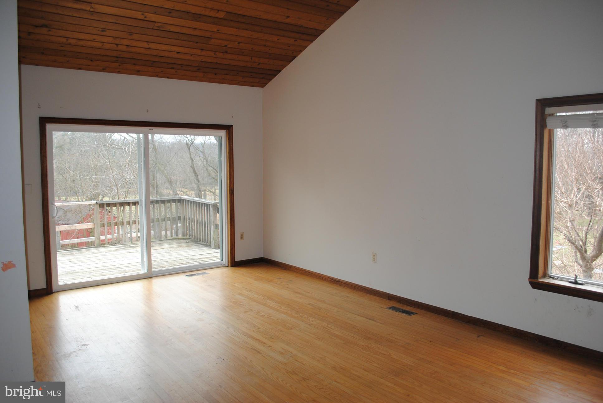 2614 Garrett Road White Hall, MD 21161 - Photo 10 of 27 an empty room with wooden floor and windows