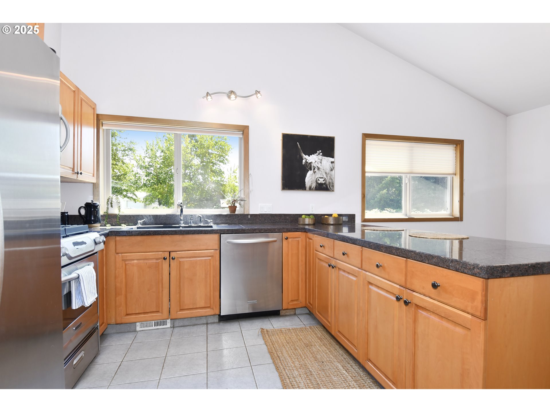 8325 Northeast Dog Ridge Road Newberg, OR 97132 - Photo 4 of 41 a kitchen with stainless steel appliances granite countertop a stove a sink and a microwave