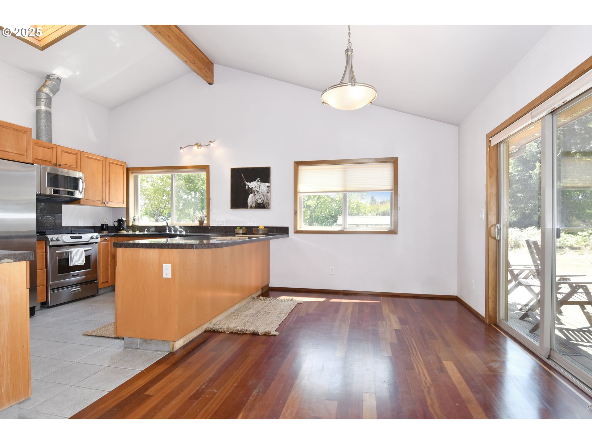 8325 Northeast Dog Ridge Road Newberg, OR 97132 - Photo 5 of 41 a living room with stainless steel appliances kitchen island granite countertop a stove a refrigerator a sink a dining table and chairs with wooden floor