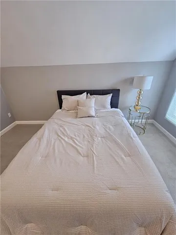 a large white bed in a white room