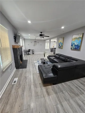 a living room with furniture and a wooden floor