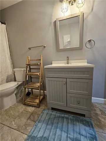 a spacious bedroom with a bed and a ceiling fan