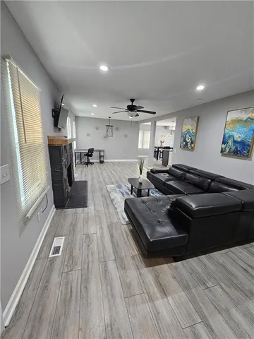 a living room with furniture and a wooden floor