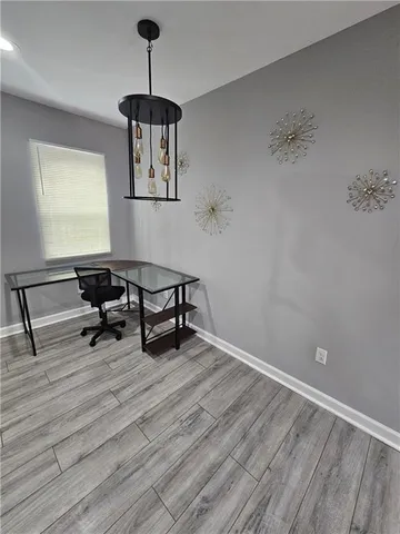a room with lots of wooden furniture and a ceiling fan