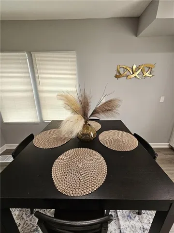 a kitchen with stainless steel appliances kitchen island granite countertop a sink dishwasher a stove a refrigerator and cabinets with wooden floor