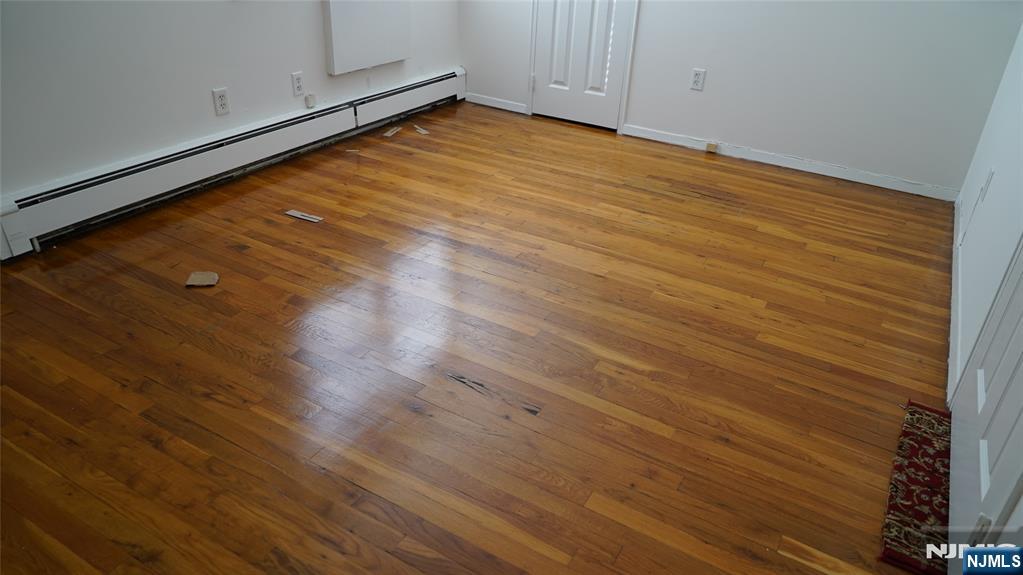 403 Anderson Avenue, Unit 4B Fairview, NJ 07022 - Photo 11 of 12 a view of empty room with wooden floor