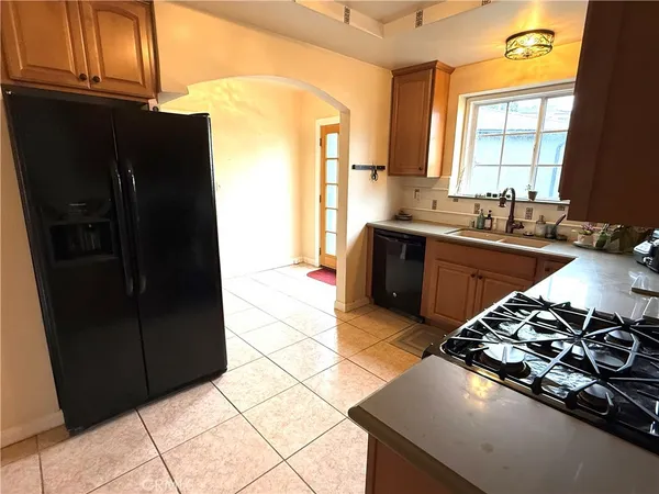 a kitchen with a sink a stove and a refrigerator