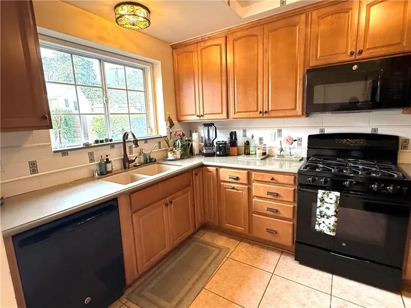 a kitchen with a sink stove and microwave