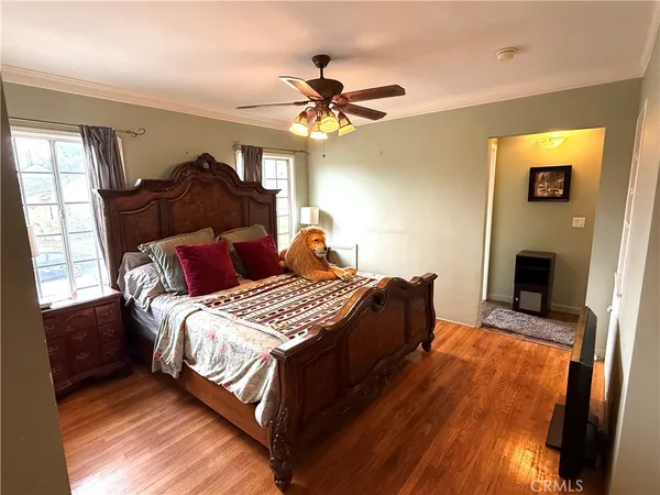 a bedroom with a bed and a chandelier