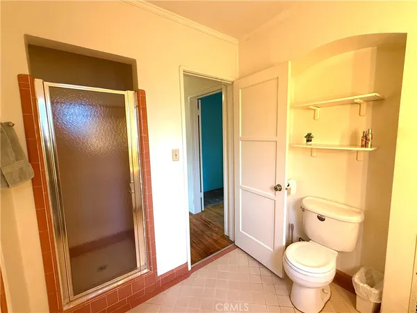 a bathroom with a granite countertop toilet and a sink