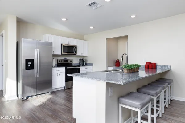 a kitchen with stainless steel appliances a refrigerator stove and microwave