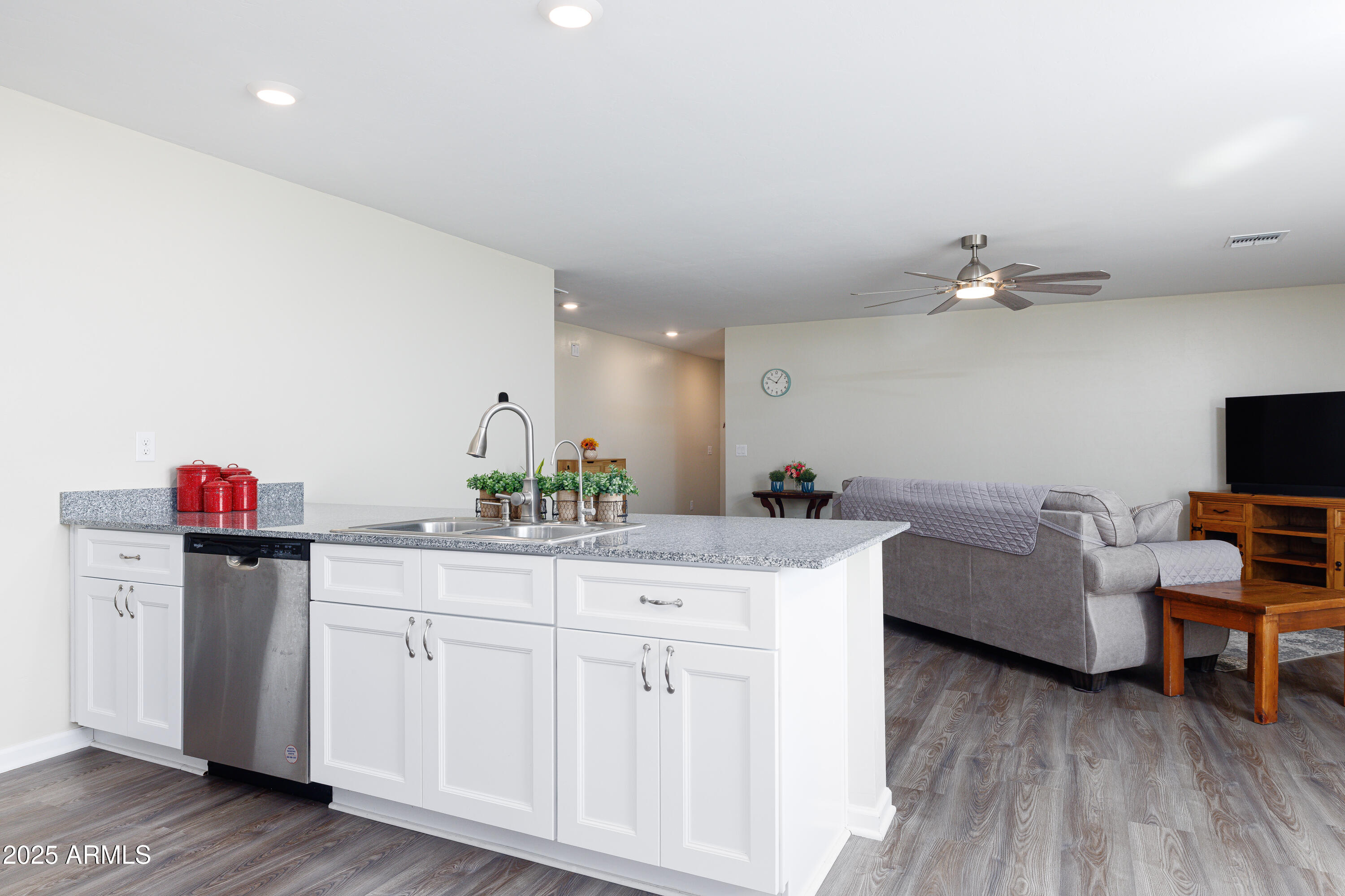 1256 South Lenora Loop Benson, AZ 85602 - Photo 12 of 34 a kitchen with a sink dishwasher and a stove with wooden floor