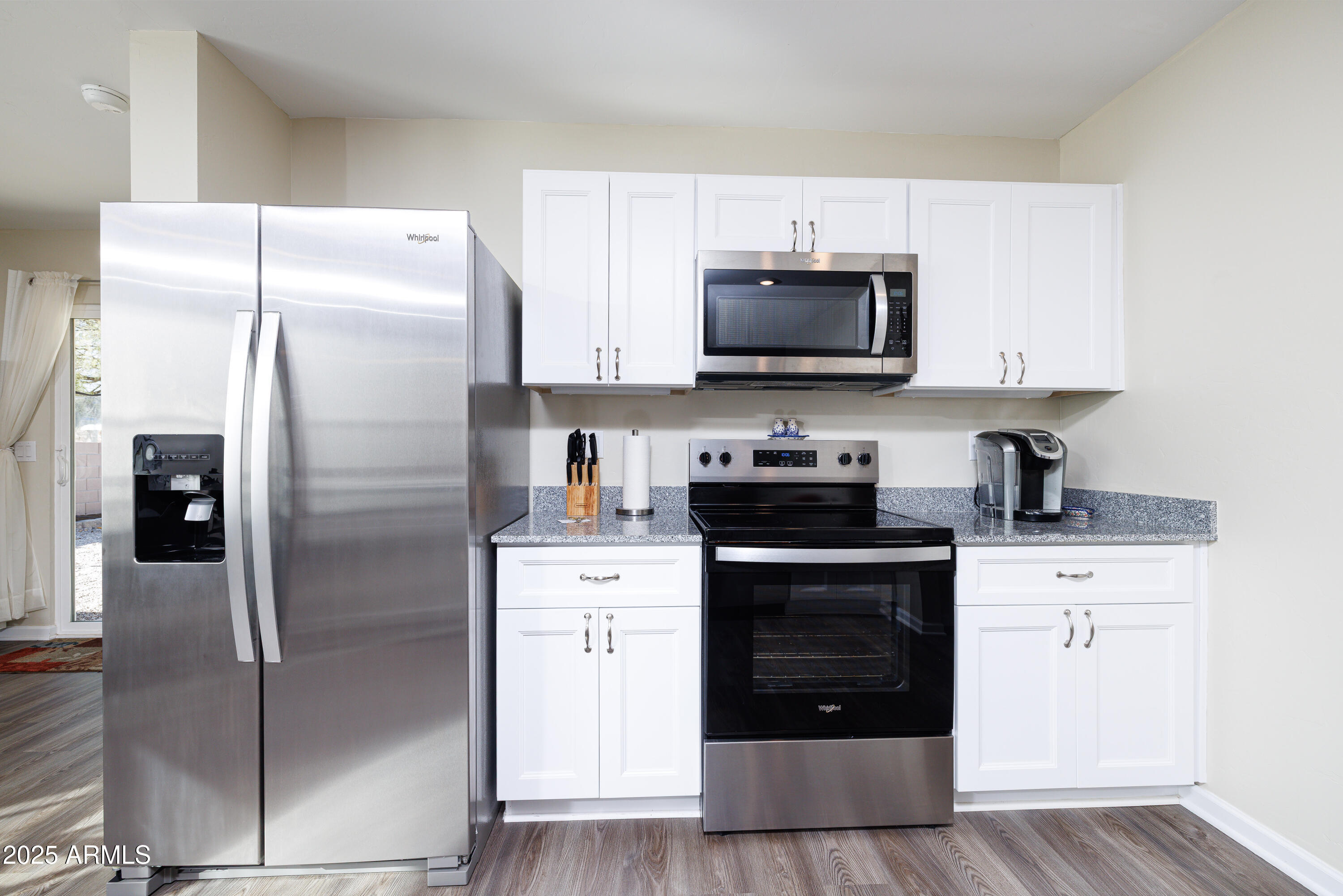 1256 South Lenora Loop Benson, AZ 85602 - Photo 13 of 34 a kitchen with stainless steel appliances a refrigerator stove and microwave