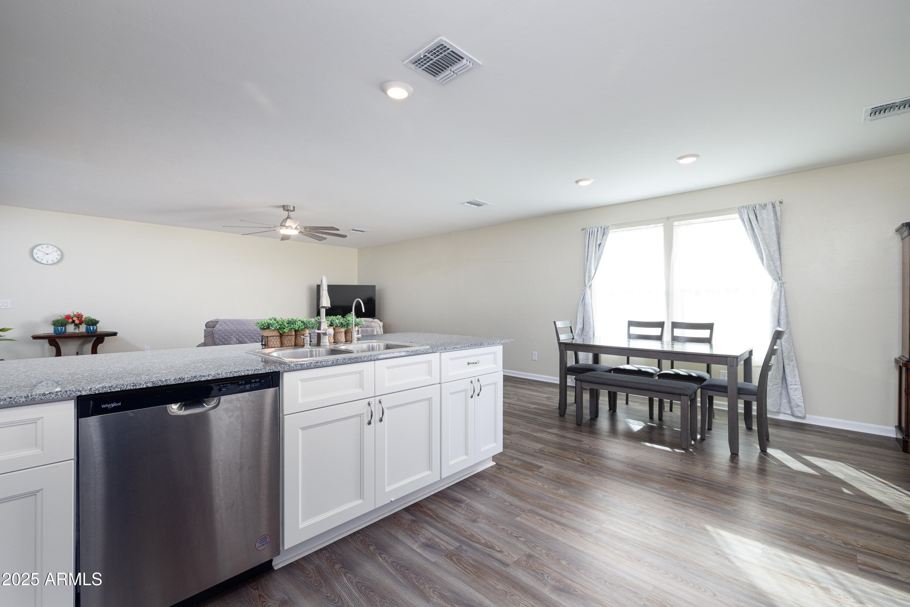 1256 South Lenora Loop Benson, AZ 85602 - Photo 14 of 34 a kitchen with a dining table chairs wooden floor and appliances