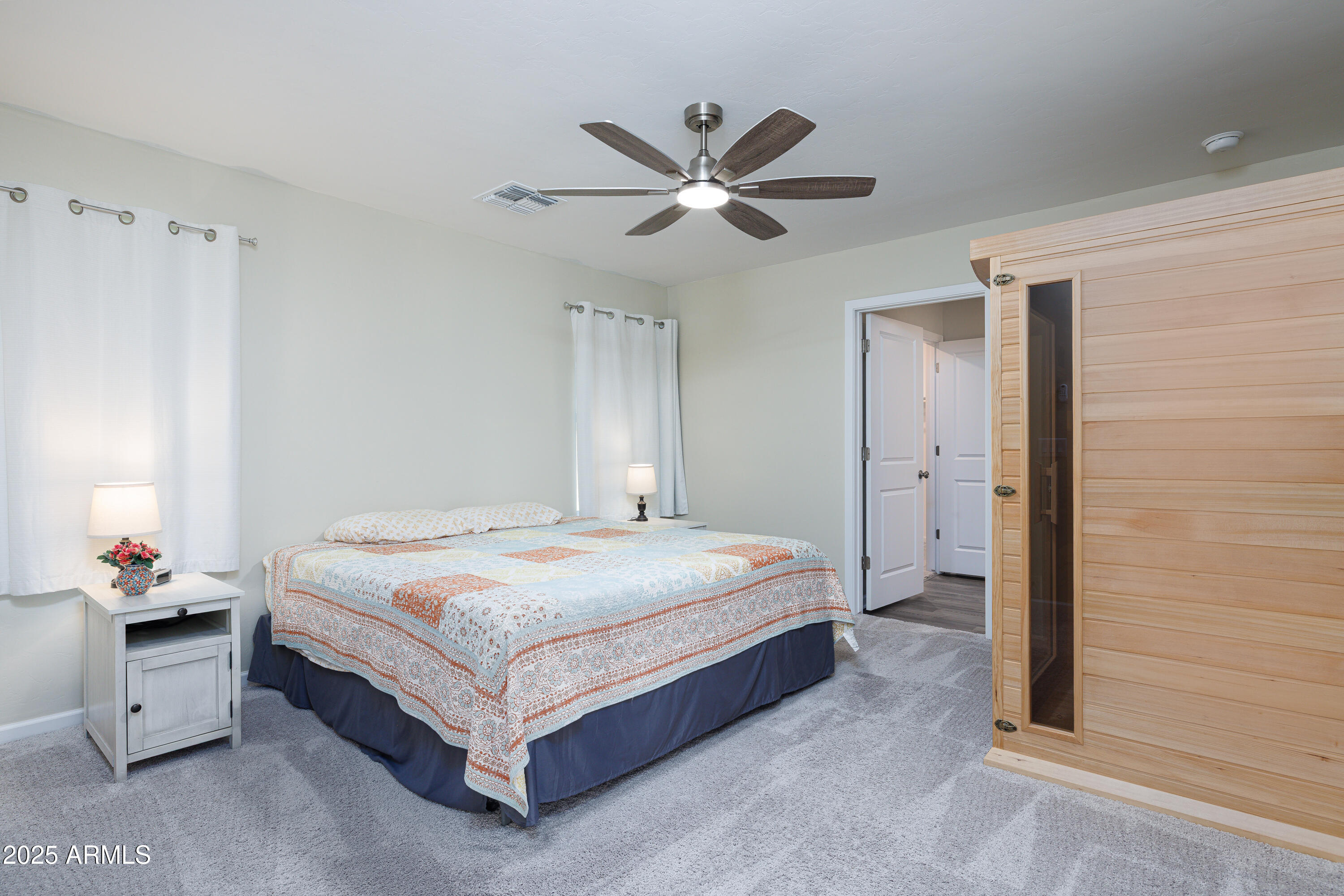 1256 South Lenora Loop Benson, AZ 85602 - Photo 16 of 34 a bedroom with a bed and a ceiling fan