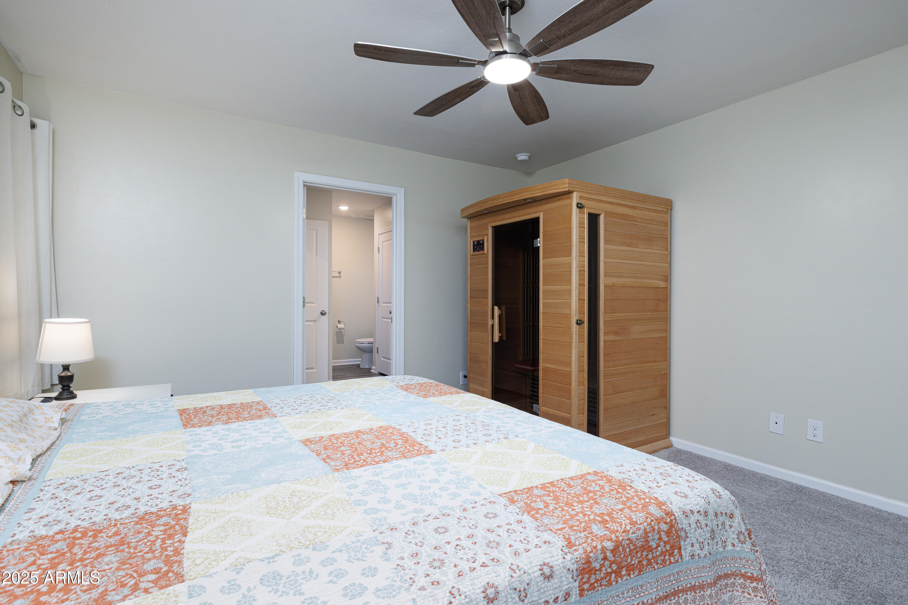 1256 South Lenora Loop Benson, AZ 85602 - Photo 17 of 34 a bedroom with a large bed and a chandelier