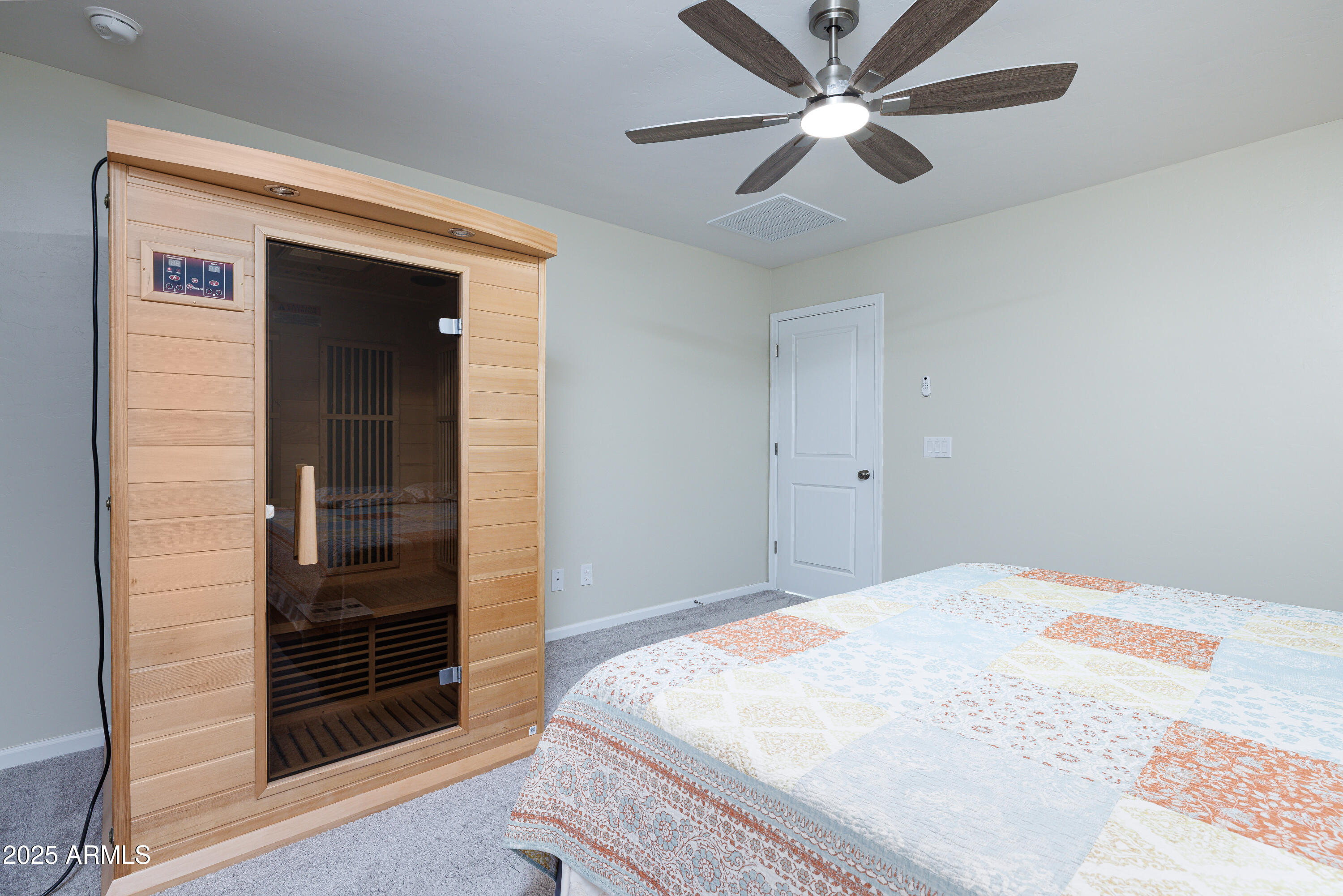 1256 South Lenora Loop Benson, AZ 85602 - Photo 18 of 34 a bedroom with a bed and a ceiling fan