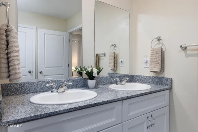 a view of walk in closet with clothes