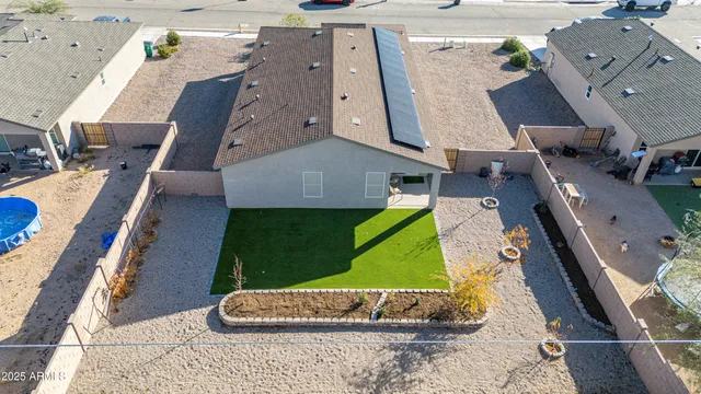 an aerial view of a house with a yard