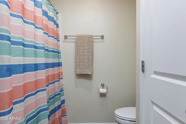 a view of walk in closet with clothes