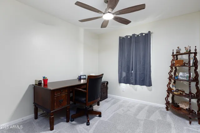 a living room with furniture cabinets and a window