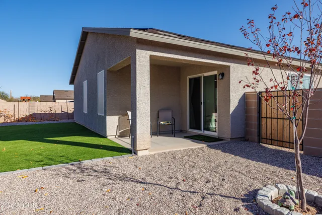 a view of a backyard with a garden and seating area