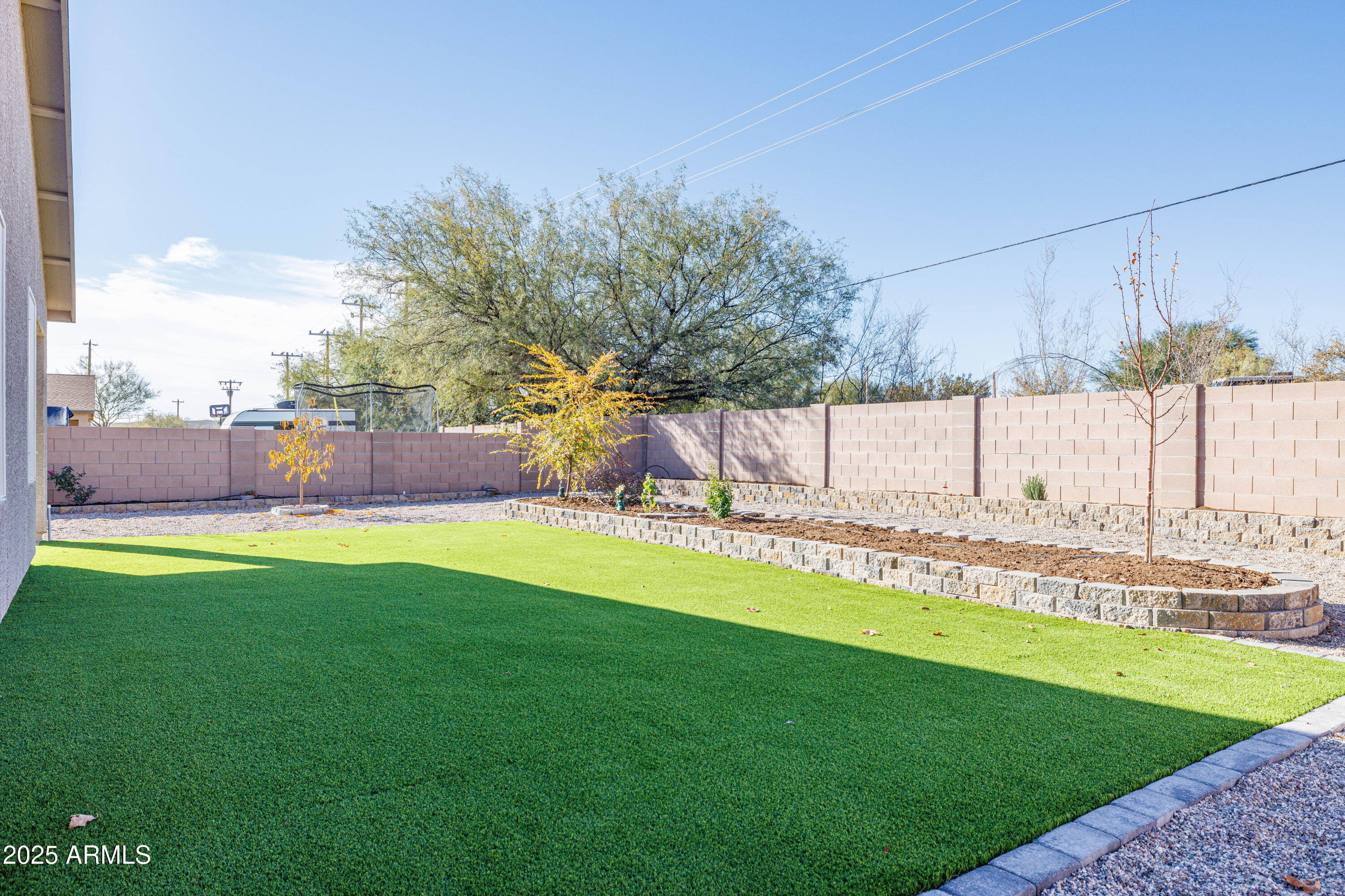 1256 South Lenora Loop Benson, AZ 85602 - Photo 34 of 34 a view of a backyard with a garden and seating area