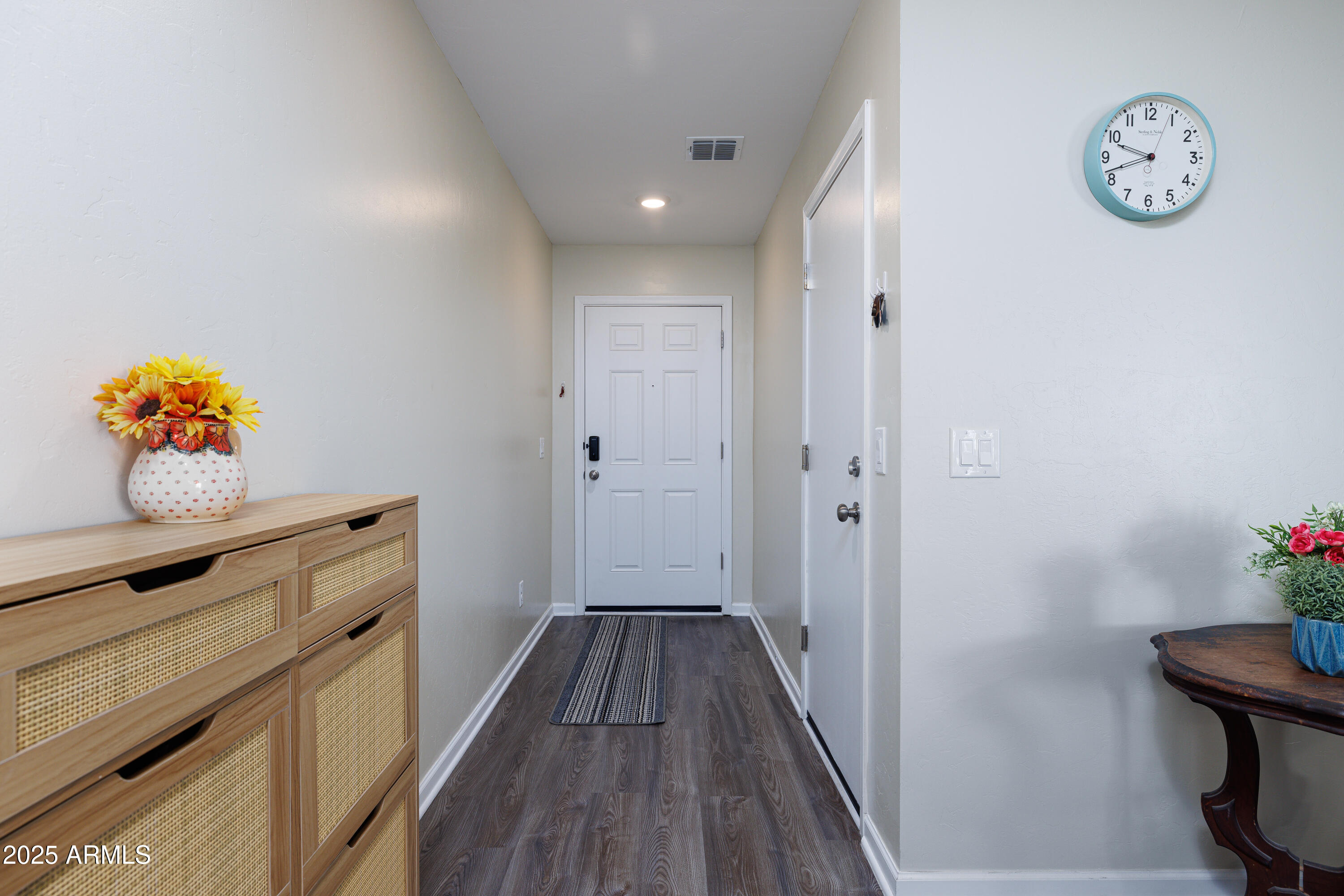 1256 South Lenora Loop Benson, AZ 85602 - Photo 5 of 34 a hallway with cabinet and wooden floor