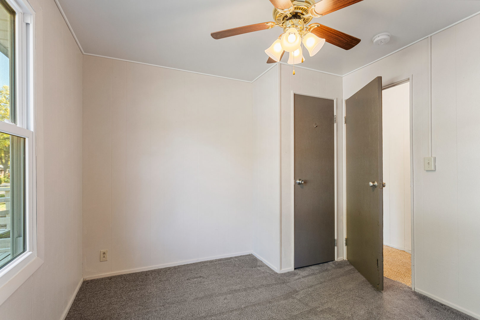 1905 Rainbow View Urbana, IL 61802 - Photo 11 of 20 an empty room with a window and a fan