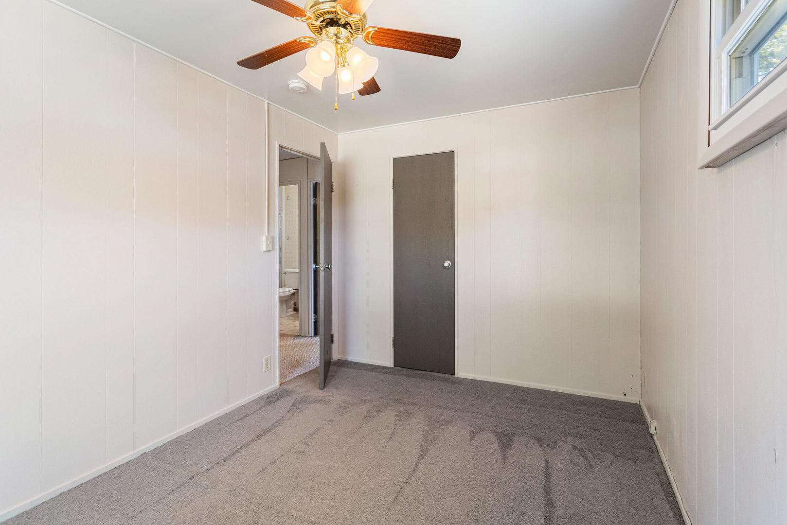 1905 Rainbow View Urbana, IL 61802 - Photo 13 of 20 an empty room with a chandelier fan and windows