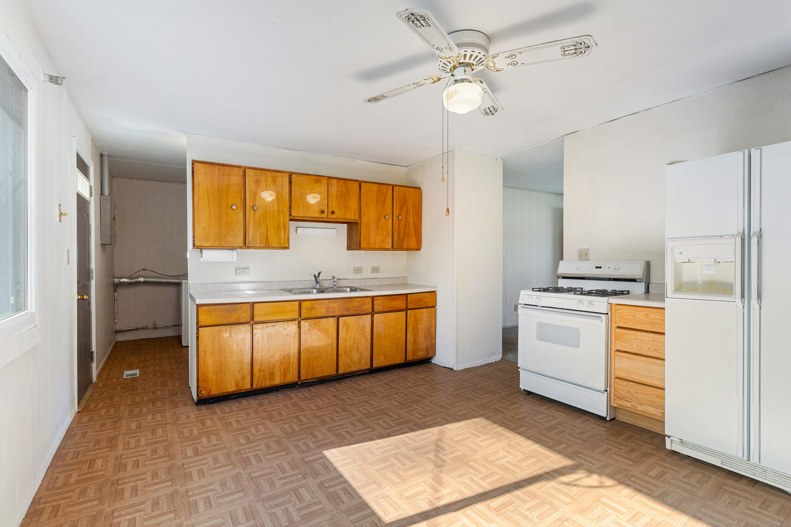 1905 Rainbow View Urbana, IL 61802 - Photo 8 of 20 a kitchen with stainless steel appliances granite countertop a sink a stove a refrigerator cabinets and living room view
