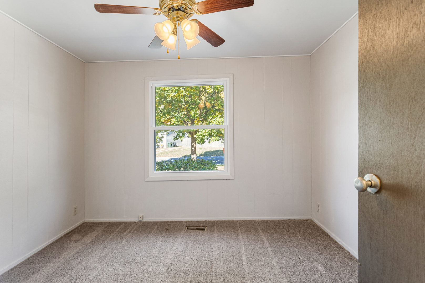 1905 Rainbow View Urbana, IL 61802 - Photo 10 of 20 an empty room with a window and a fan