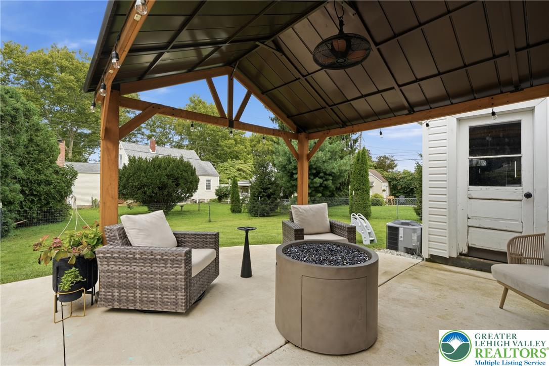 408 Maple Road Hellertown, PA 18055 - Photo 46 of 66 An inviting covered patio features a concrete surface looking out onto a grassy yard.
