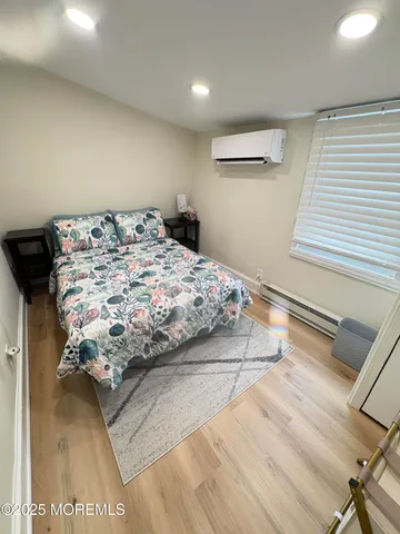 a bedroom with a bed and a night stand