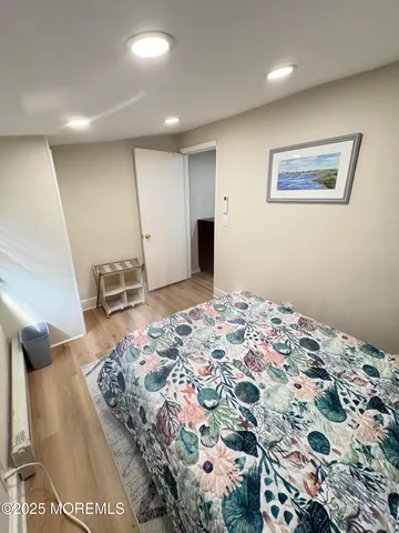 a bedroom with bed and mirror