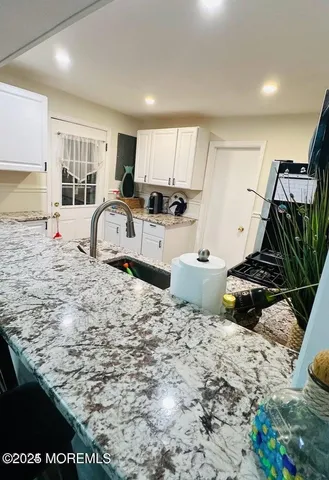 a large bed sitting in a room next to a window