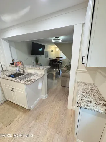 a kitchen with stainless steel appliances granite countertop a sink stove and cabinets
