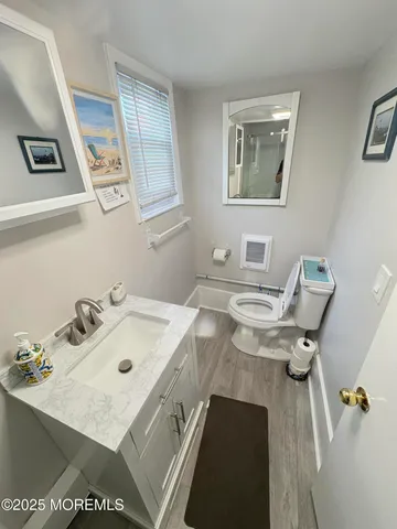 a view of a workspace with furniture and mirror